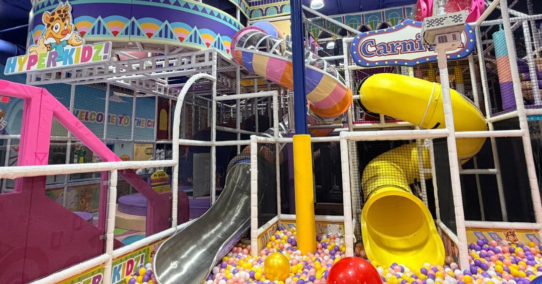 Multi-level indoor playground with spiral slides and a colorful ball pit at Hyper Kidz Richmond