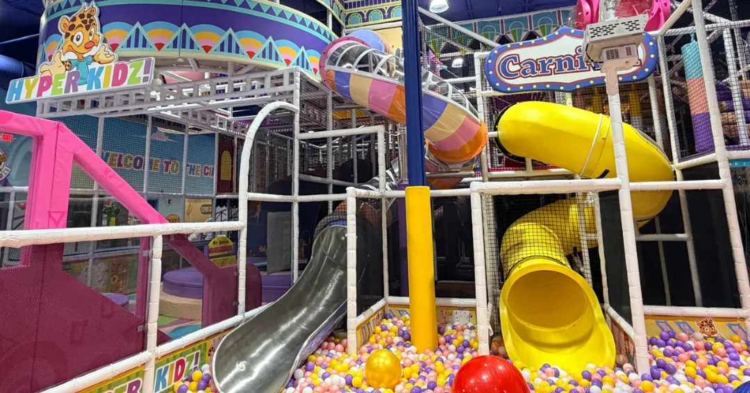 Multi-level indoor playground with spiral slides and a colorful ball pit at Hyper Kidz Richmond
